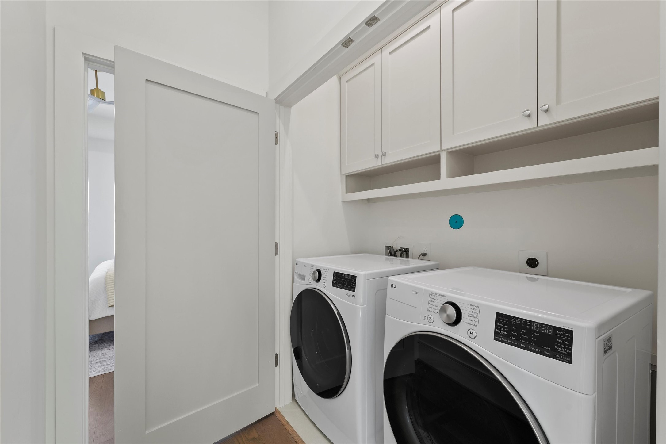 5407 Dickson Street Houston, TX 77007 - Photo 24 of 31 a view of washer and dryer with kitchen in the background