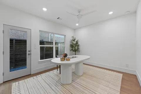 a dining room with furniture and wooden floor