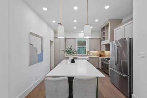 a kitchen with a refrigerator a sink and a refrigerator