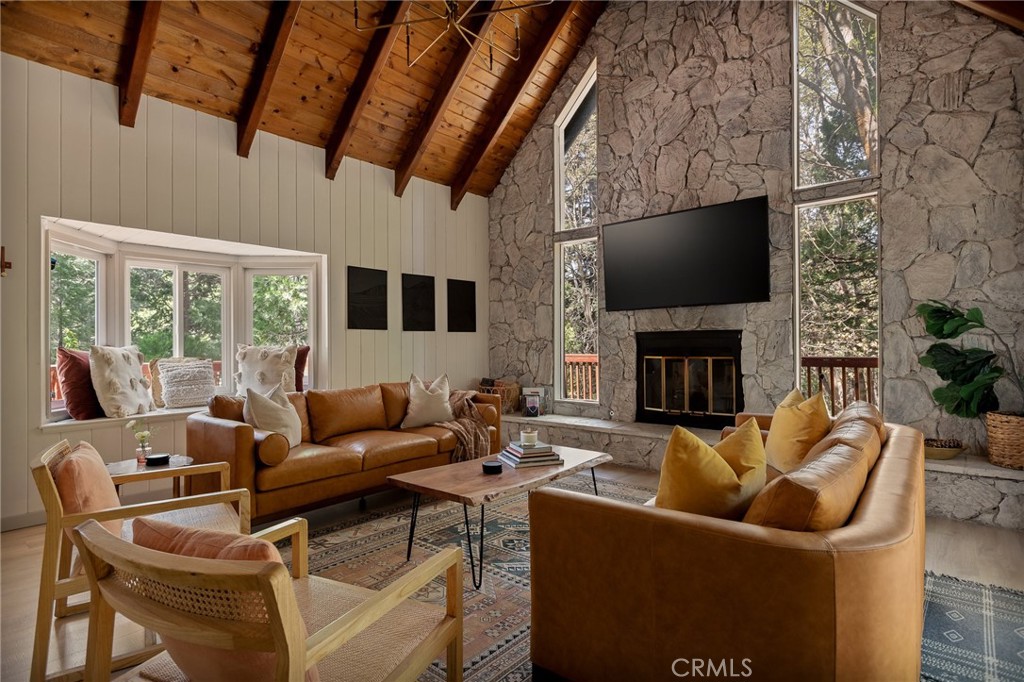373 Summit Road Lake Arrowhead, CA 92352 - Photo 20 of 41 a living room with furniture a fireplace and a flat screen tv