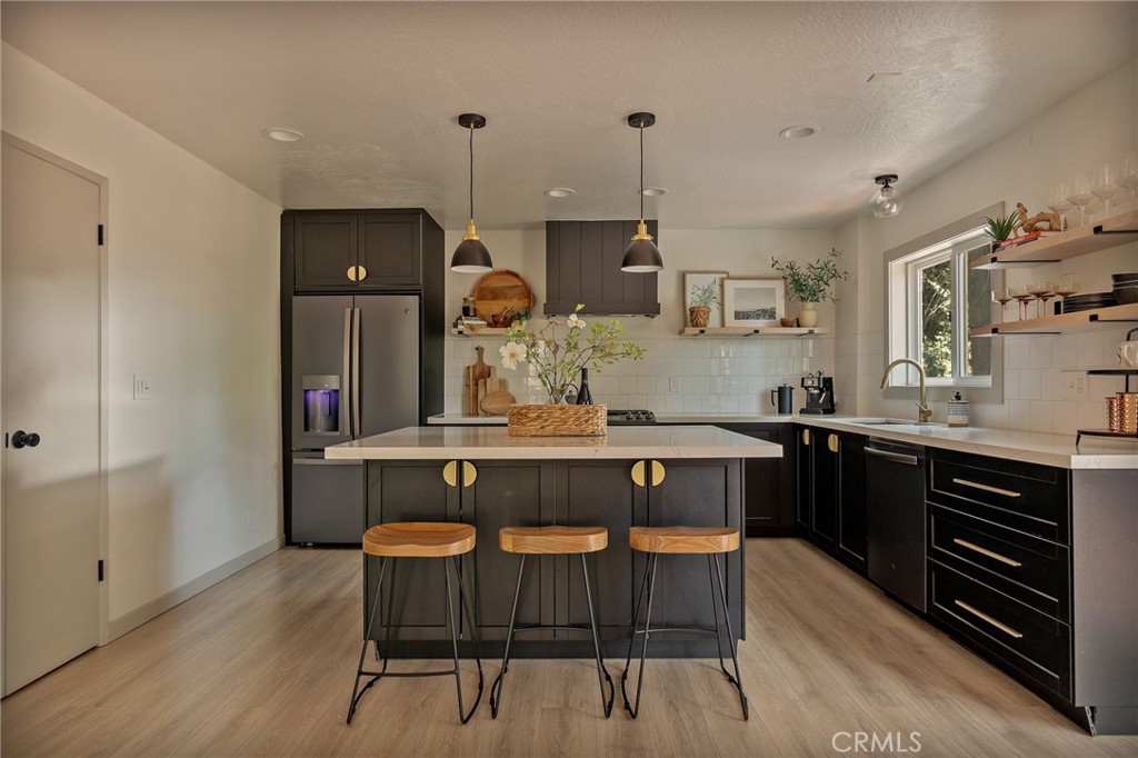 373 Summit Road Lake Arrowhead, CA 92352 - Photo 23 of 41 a kitchen with a table chairs sink and wooden floor