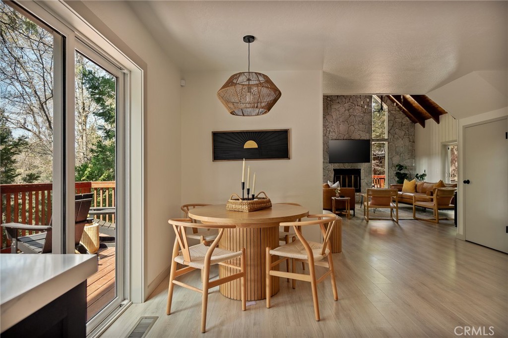 373 Summit Road Lake Arrowhead, CA 92352 - Photo 27 of 41 a view of a dining room with furniture window and wooden floor