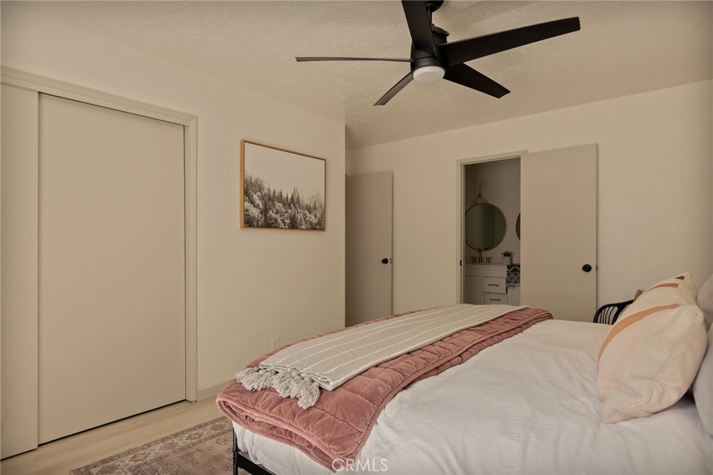 373 Summit Road Lake Arrowhead, CA 92352 - Photo 29 of 41 a bedroom with a bed and a chandelier