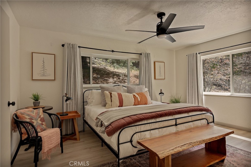 373 Summit Road Lake Arrowhead, CA 92352 - Photo 6 of 41 a bedroom with a bed and wooden floor