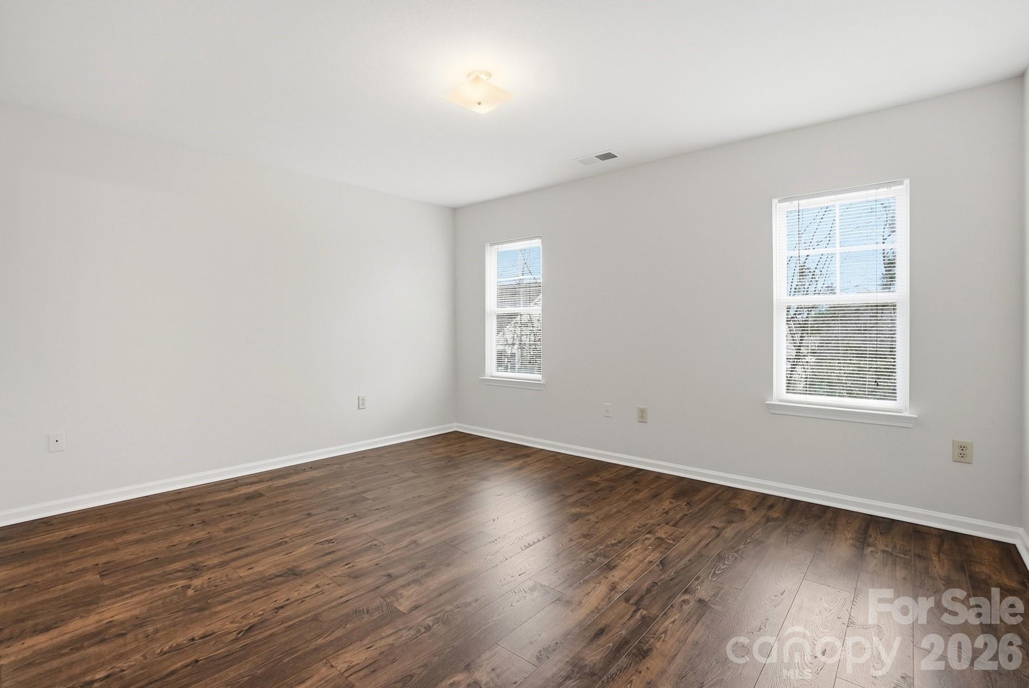 711 Stone Village Drive Fort Mill, SC 29708 - Photo 35 of 46 an empty room with wooden floor and windows