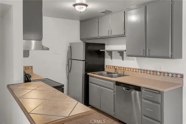 a stove top oven sitting inside of a kitchen
