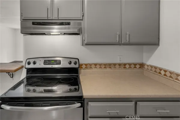 a kitchen with a sink cabinets and appliances
