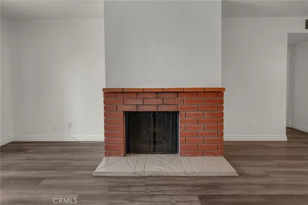 wooden floor in an empty room with a fireplace