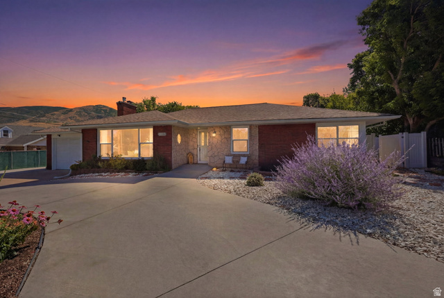 1180 North 400 East Bountiful, UT 84010 - Photo 2 of 50 Ranch-style residence featuring a brick facade, stone accents, and a front-facing garage