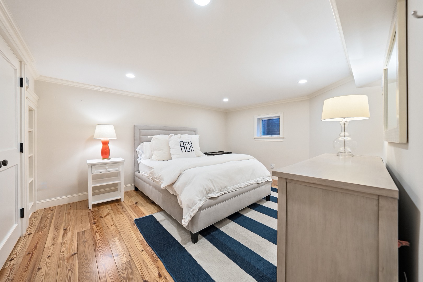 18 Mill Street Nantucket, MA 02554 - Photo 29 of 47 a bed room with a bed and a lamp