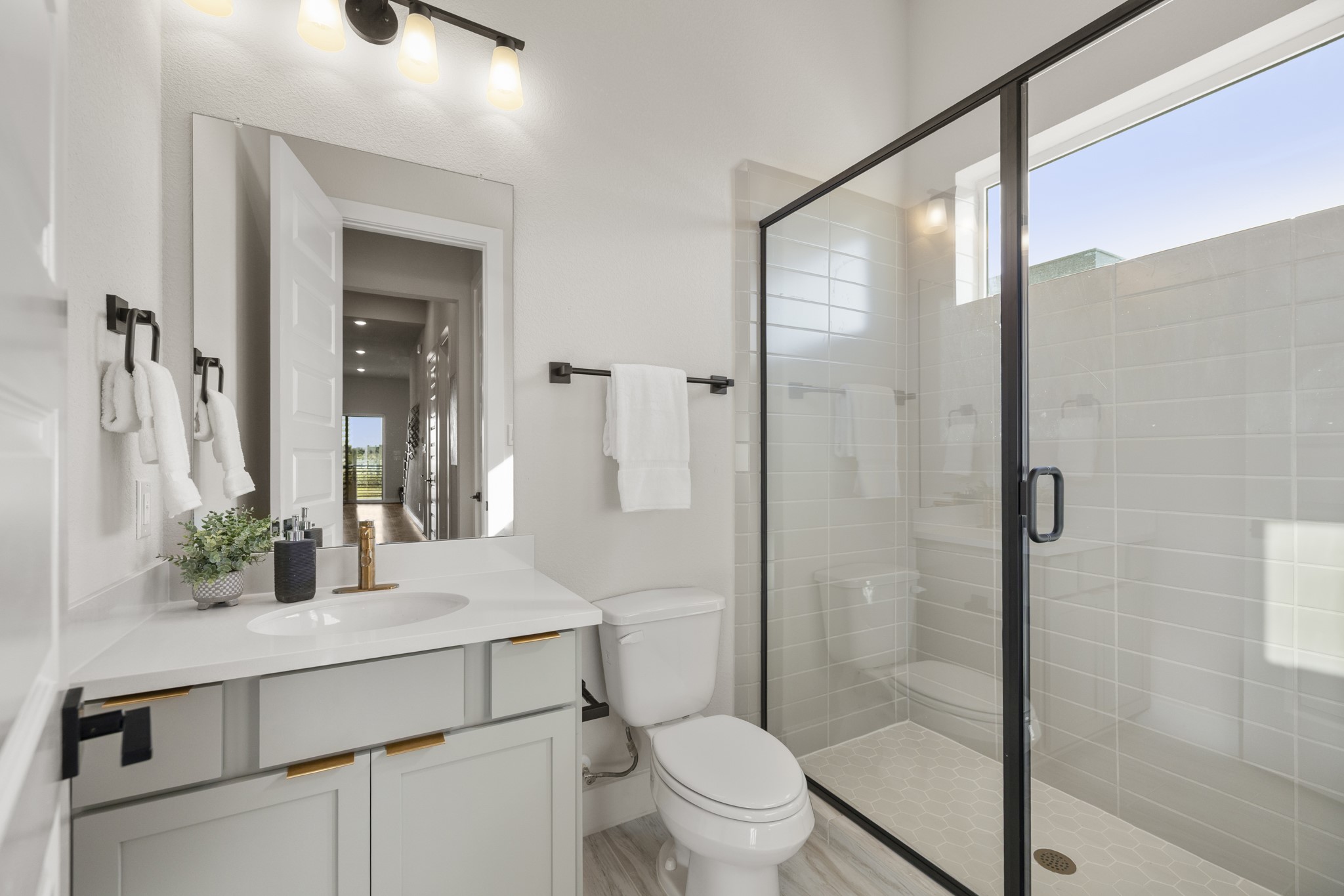 4412 Tucker Lane Seabrook, TX 77586 - Photo 31 of 41 a bathroom with a shower sink vanity mirror and toilet