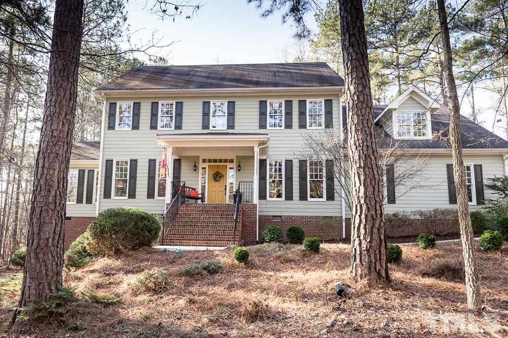 5817 North Hawthorne Way Raleigh, NC 27613 - Photo 1 of 25 a front view of a house with a yard