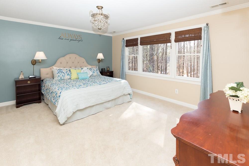 5817 North Hawthorne Way Raleigh, NC 27613 - Photo 13 of 25 a spacious bedroom with a bed and a window