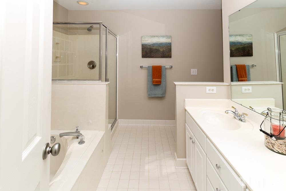 5817 North Hawthorne Way Raleigh, NC 27613 - Photo 14 of 25 a bathroom with a tub sink and mirror