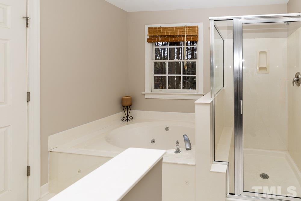 5817 North Hawthorne Way Raleigh, NC 27613 - Photo 15 of 25 a bathroom with a bathtub and shower