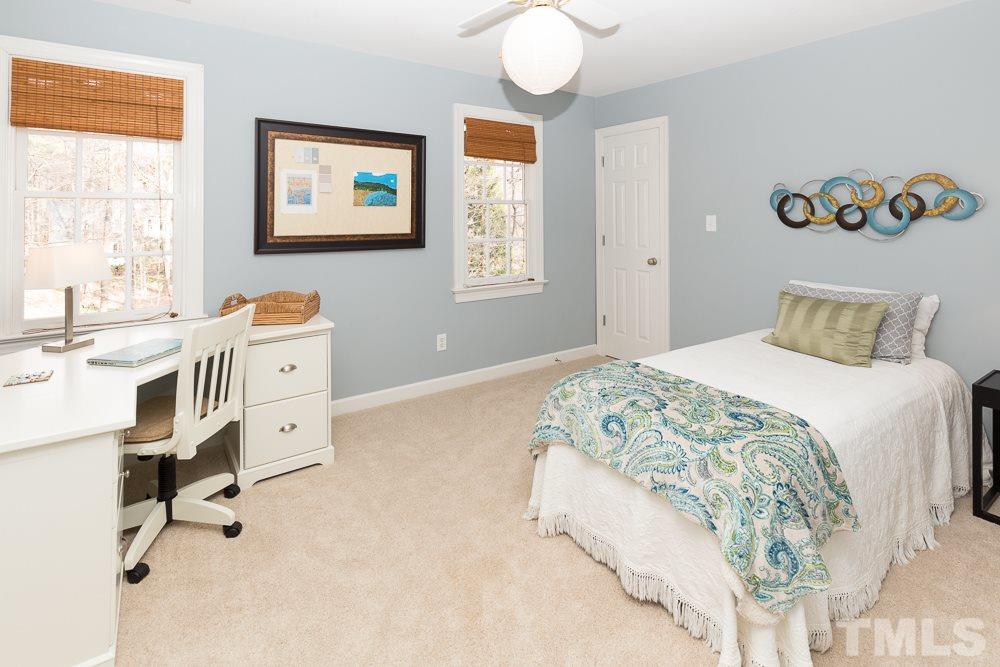 5817 North Hawthorne Way Raleigh, NC 27613 - Photo 17 of 25 a bedroom with a bed and furniture