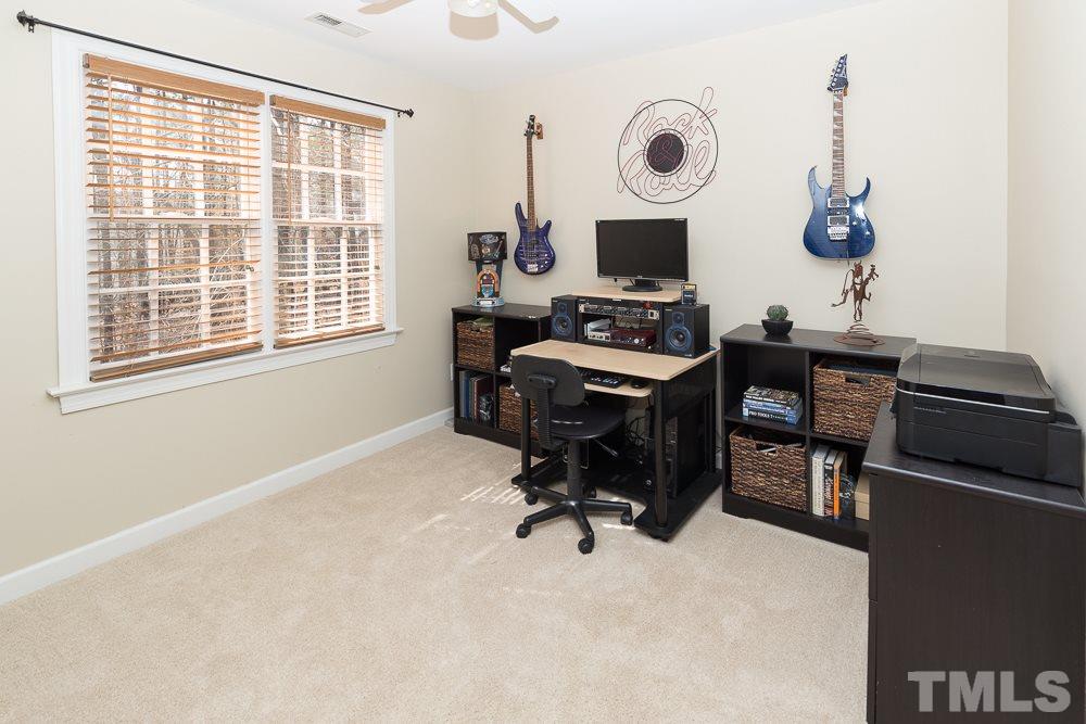 5817 North Hawthorne Way Raleigh, NC 27613 - Photo 19 of 25 a view of a workspace with furniture and a window