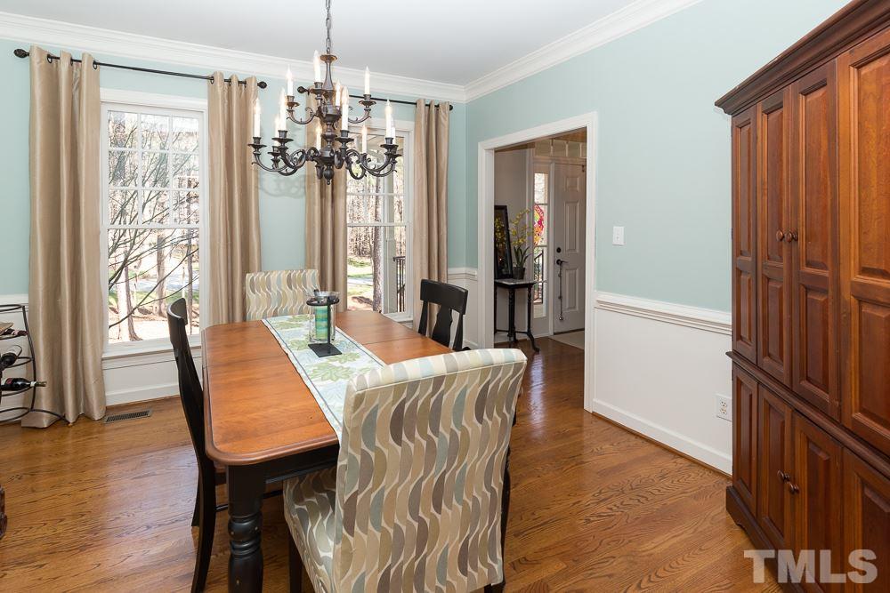 5817 North Hawthorne Way Raleigh, NC 27613 - Photo 3 of 25 a view of a dining room with furniture window and wooden floor