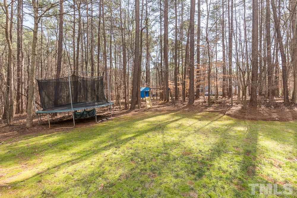 5817 North Hawthorne Way Raleigh, NC 27613 - Photo 24 of 25 a view of swimming pool with lawn chairs and large trees