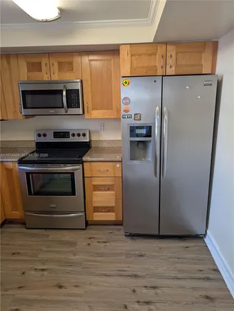 a kitchen with a refrigerator stove and microwave