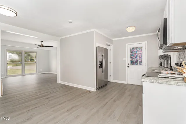 a view of a kitchen cabinets a sink and wooden floor