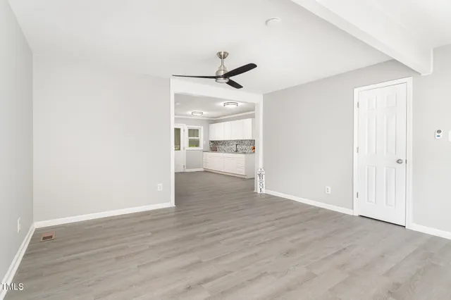 a view of a kitchen with a sink and wooden floor