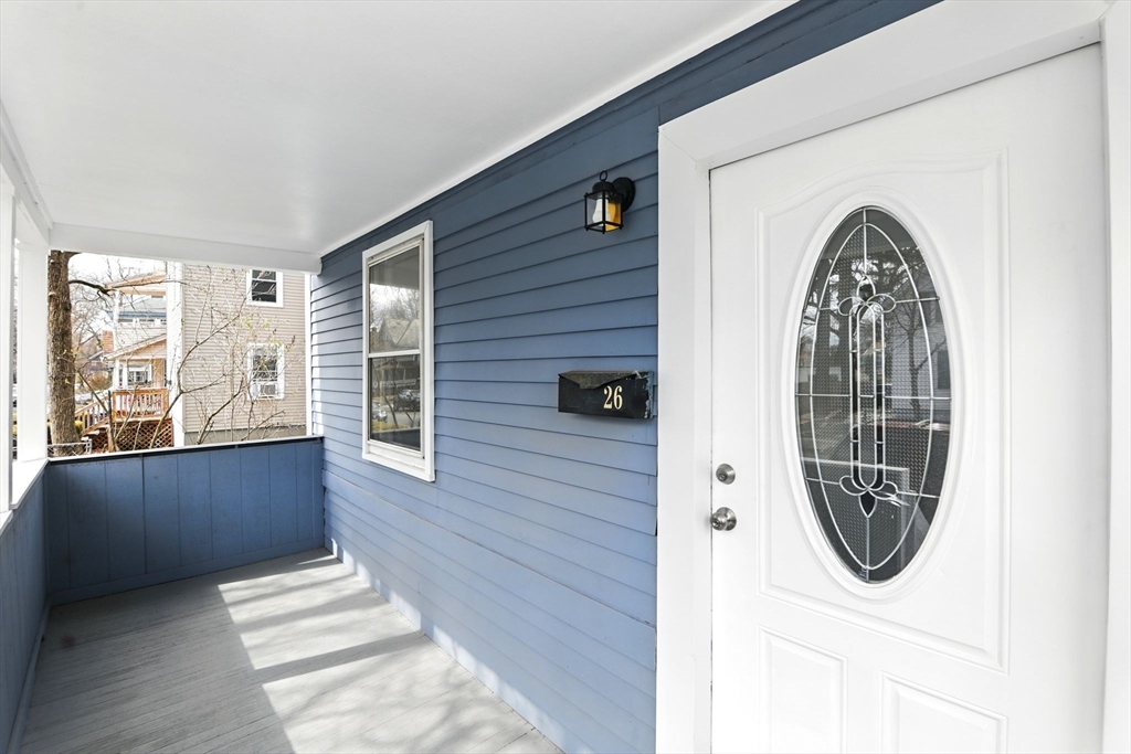 26 Forest Street Springfield, MA 01108 - Photo 5 of 32 a front view of a house with wooden floor and a white door