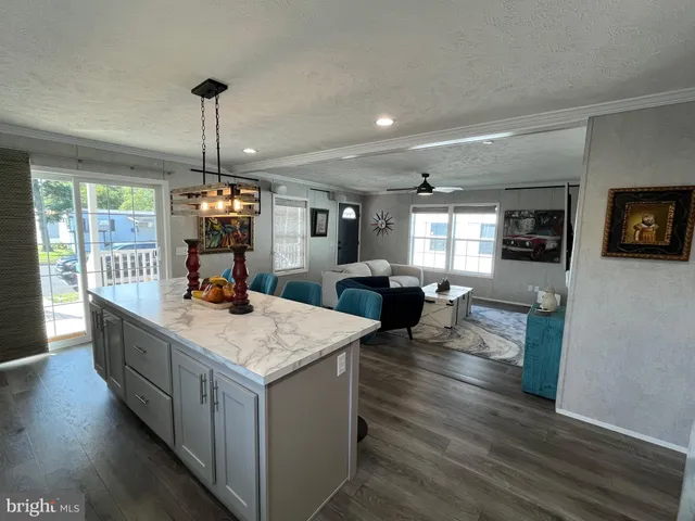 a kitchen with sink cabinets and wooden floor