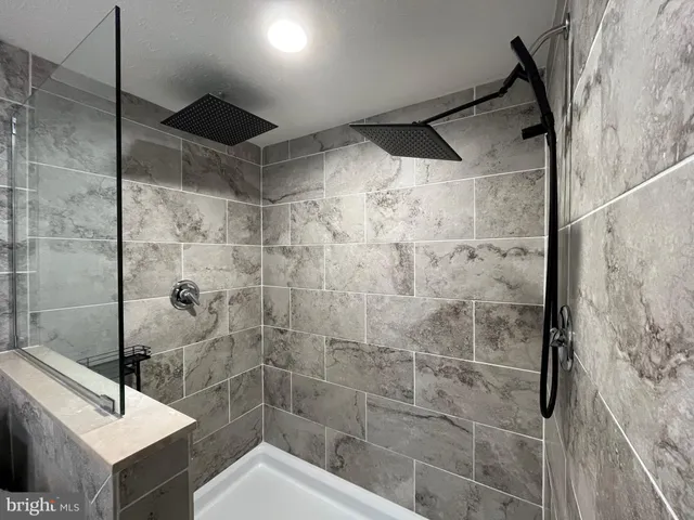 a bathroom with a shower and a sink