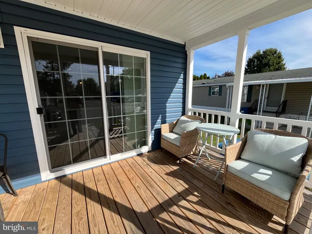 a balcony with table and chairs