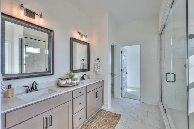 a spacious bathroom with a granite countertop sink mirror and double