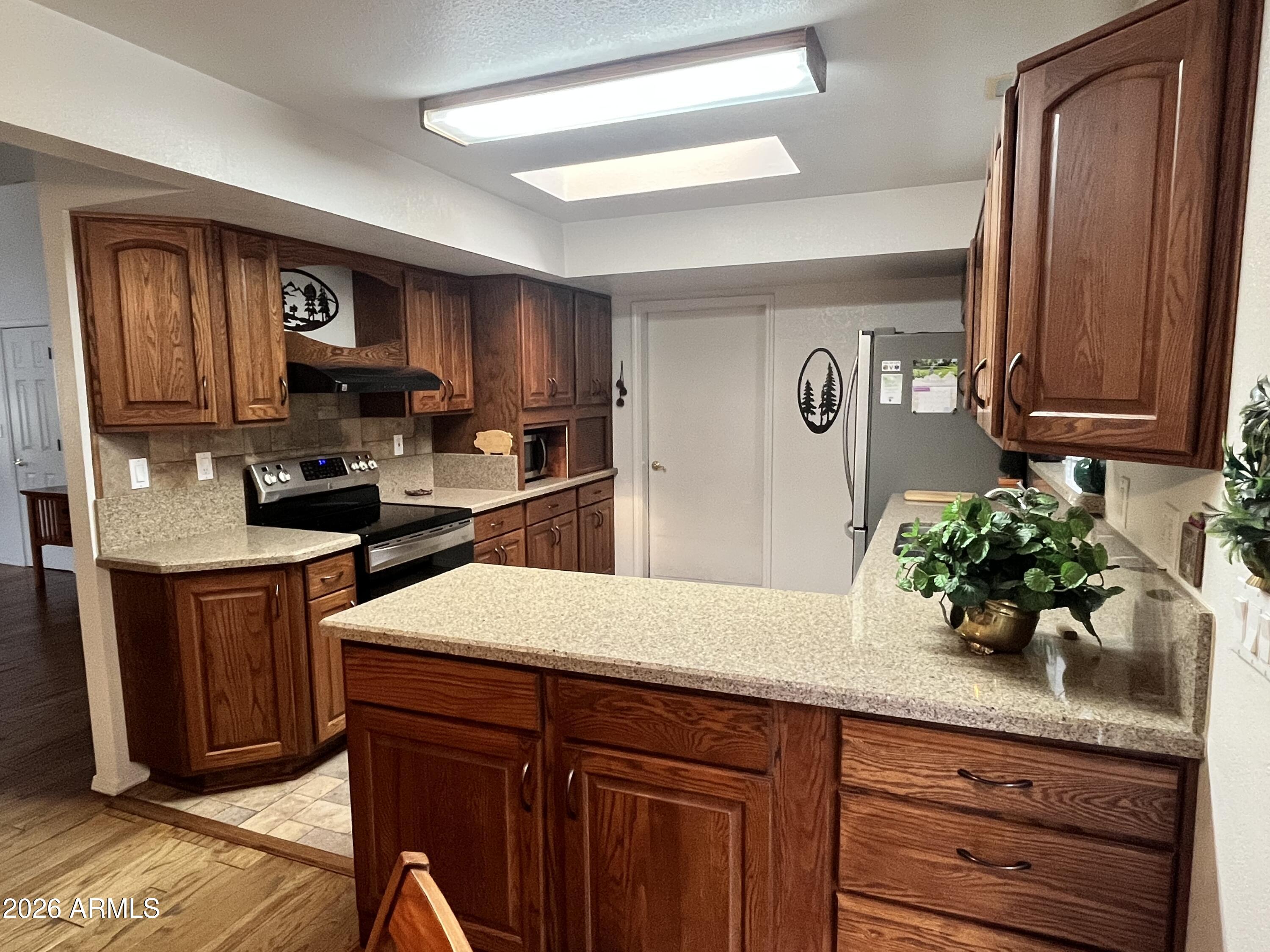 1006 North Matterhorn Road Payson, AZ 85541 - Photo 11 of 37 a kitchen with granite countertop a sink stainless steel appliances and cabinets