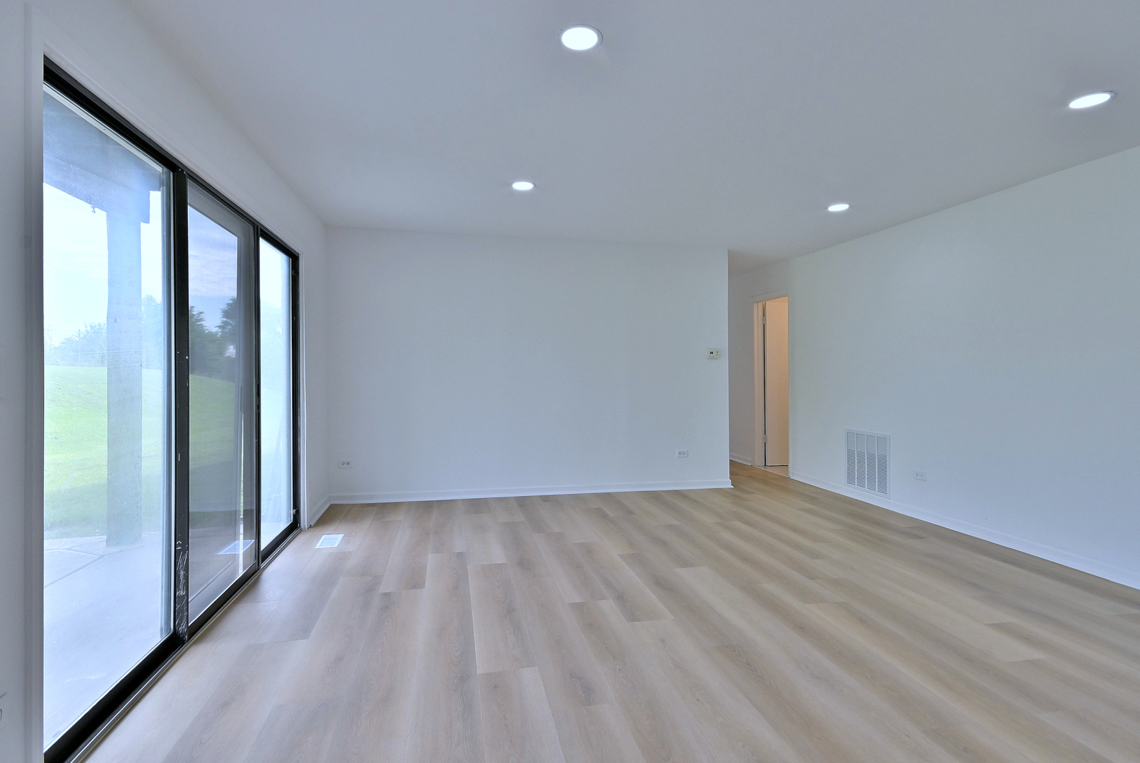 1395 Alpine Court, Unit C Hanover Park, IL 60133 - Photo 11 of 31 wooden floor in an empty room with a window