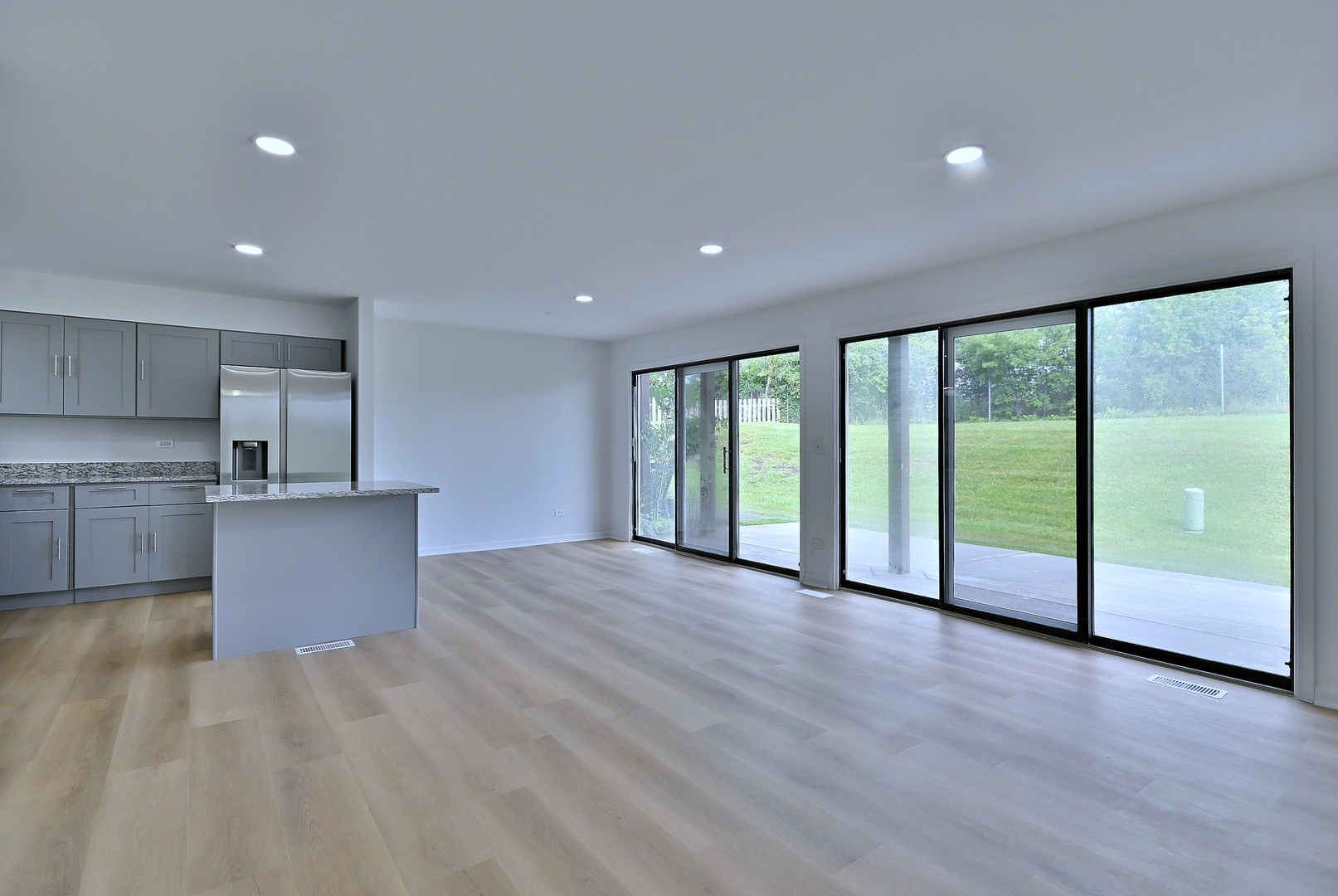 1395 Alpine Court, Unit C Hanover Park, IL 60133 - Photo 13 of 31 a view of an empty room with wooden floor and a window