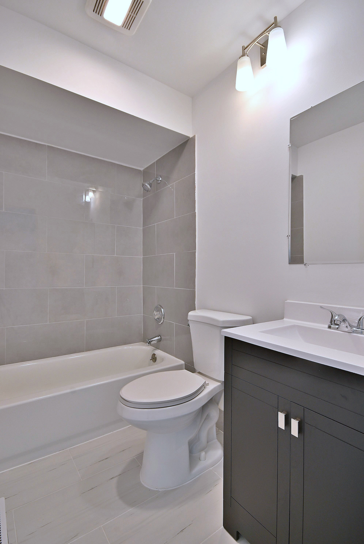 1395 Alpine Court, Unit C Hanover Park, IL 60133 - Photo 15 of 31 a bathroom with a sink toilet and shower