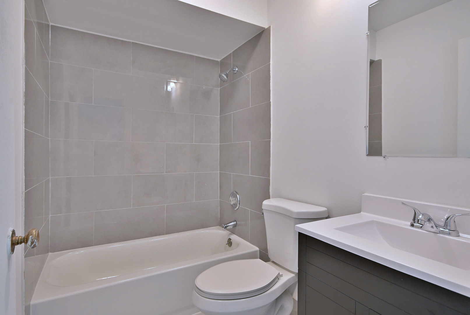 1395 Alpine Court, Unit C Hanover Park, IL 60133 - Photo 16 of 31 a bathroom with a granite countertop bathtub shower sink mirror vanity and toilet