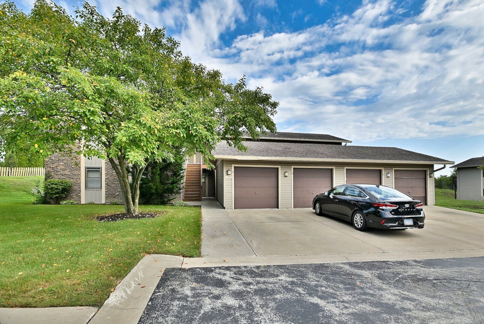 1395 Alpine Court, Unit C Hanover Park, IL 60133 - Photo 2 of 31 a car parked in front of white house