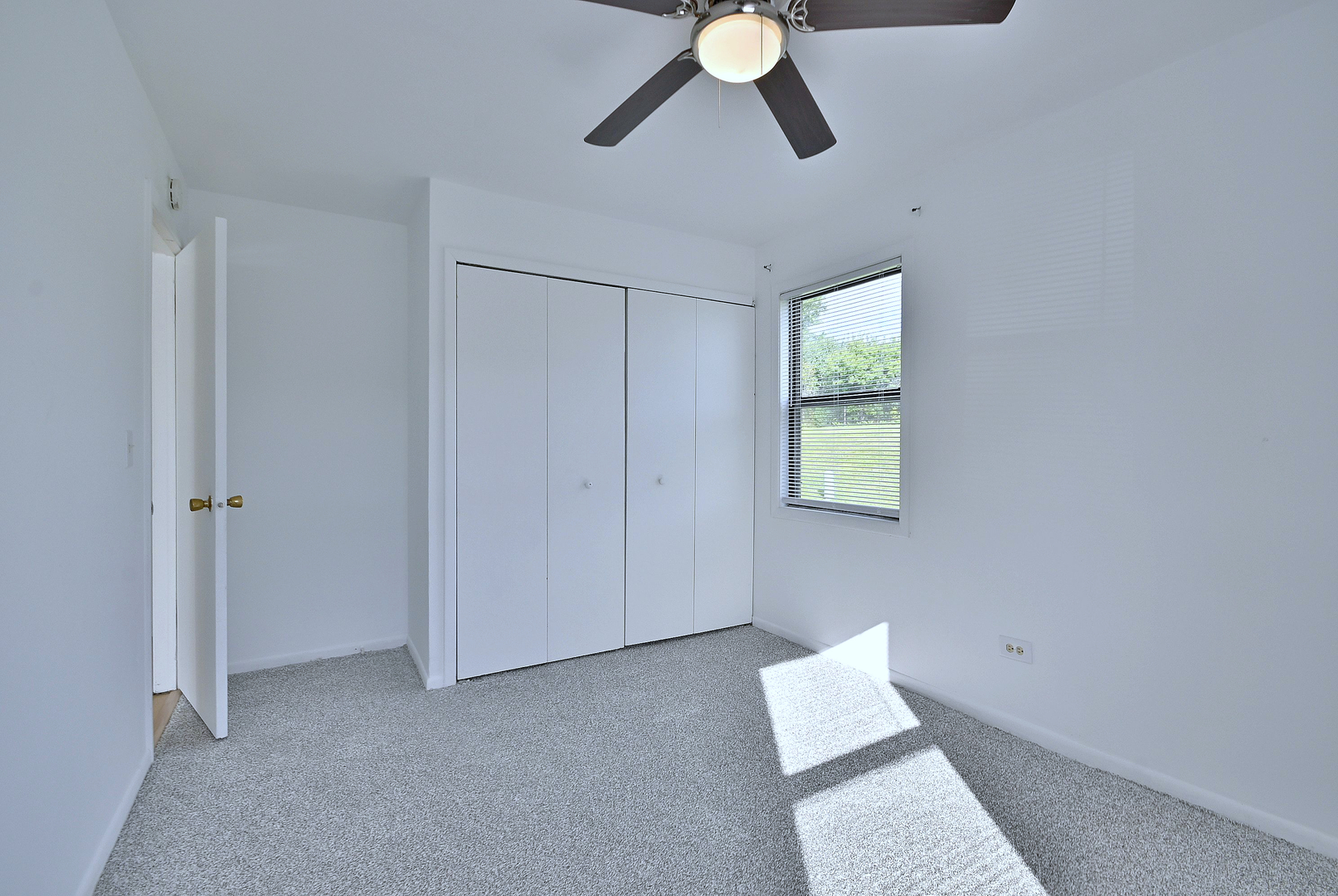 1395 Alpine Court, Unit C Hanover Park, IL 60133 - Photo 22 of 31 a view of room with windows and ceiling fan