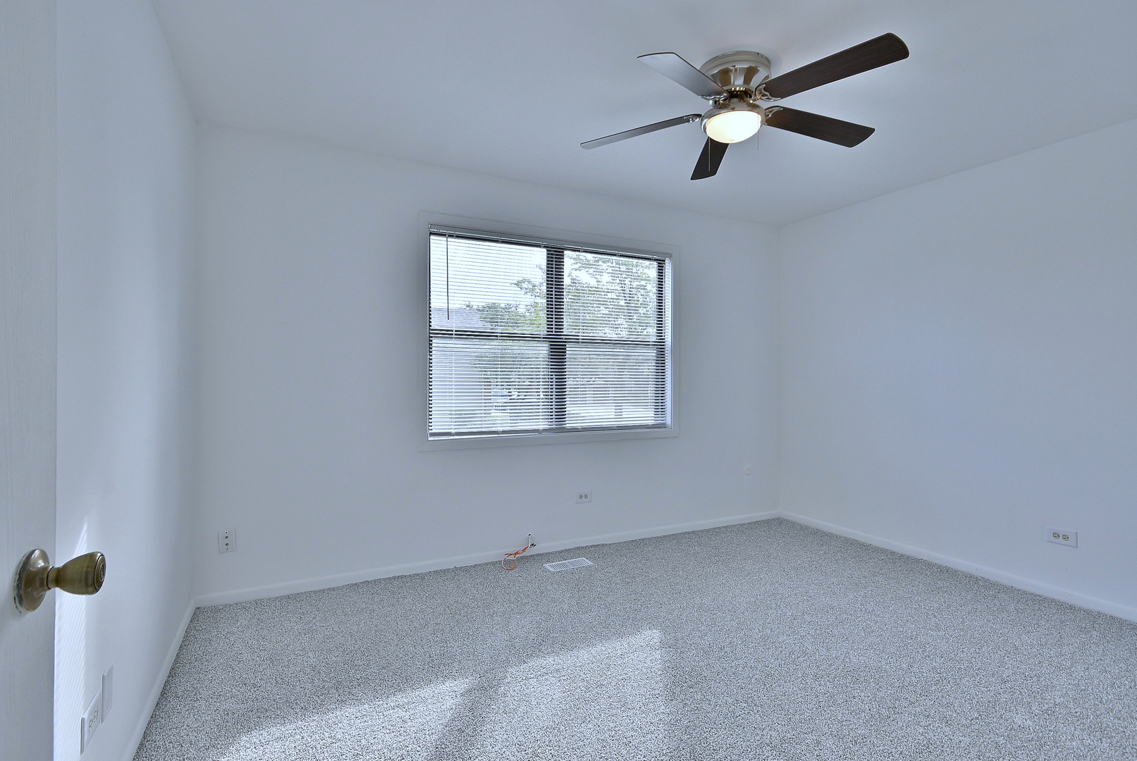 1395 Alpine Court, Unit C Hanover Park, IL 60133 - Photo 23 of 31 an empty room with a window and a fan