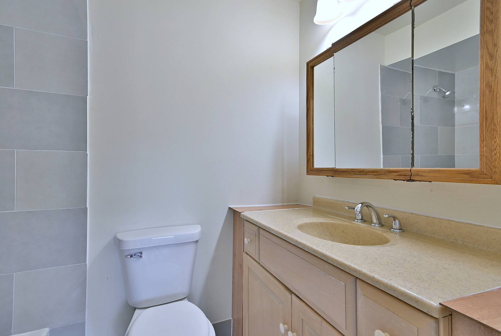 1395 Alpine Court, Unit C Hanover Park, IL 60133 - Photo 25 of 31 a bathroom with a toilet sink and mirror