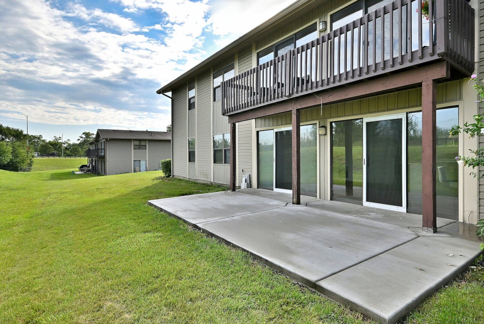 1395 Alpine Court, Unit C Hanover Park, IL 60133 - Photo 27 of 31 a view of a house with a yard and porch