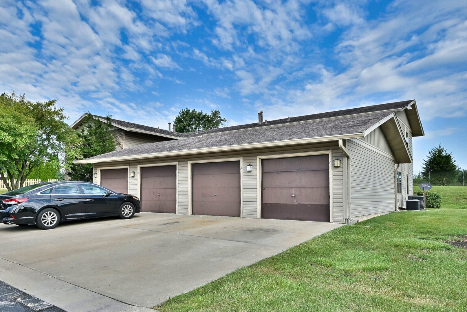 1395 Alpine Court, Unit C Hanover Park, IL 60133 - Photo 3 of 31 a front view of a house with a yard and garage