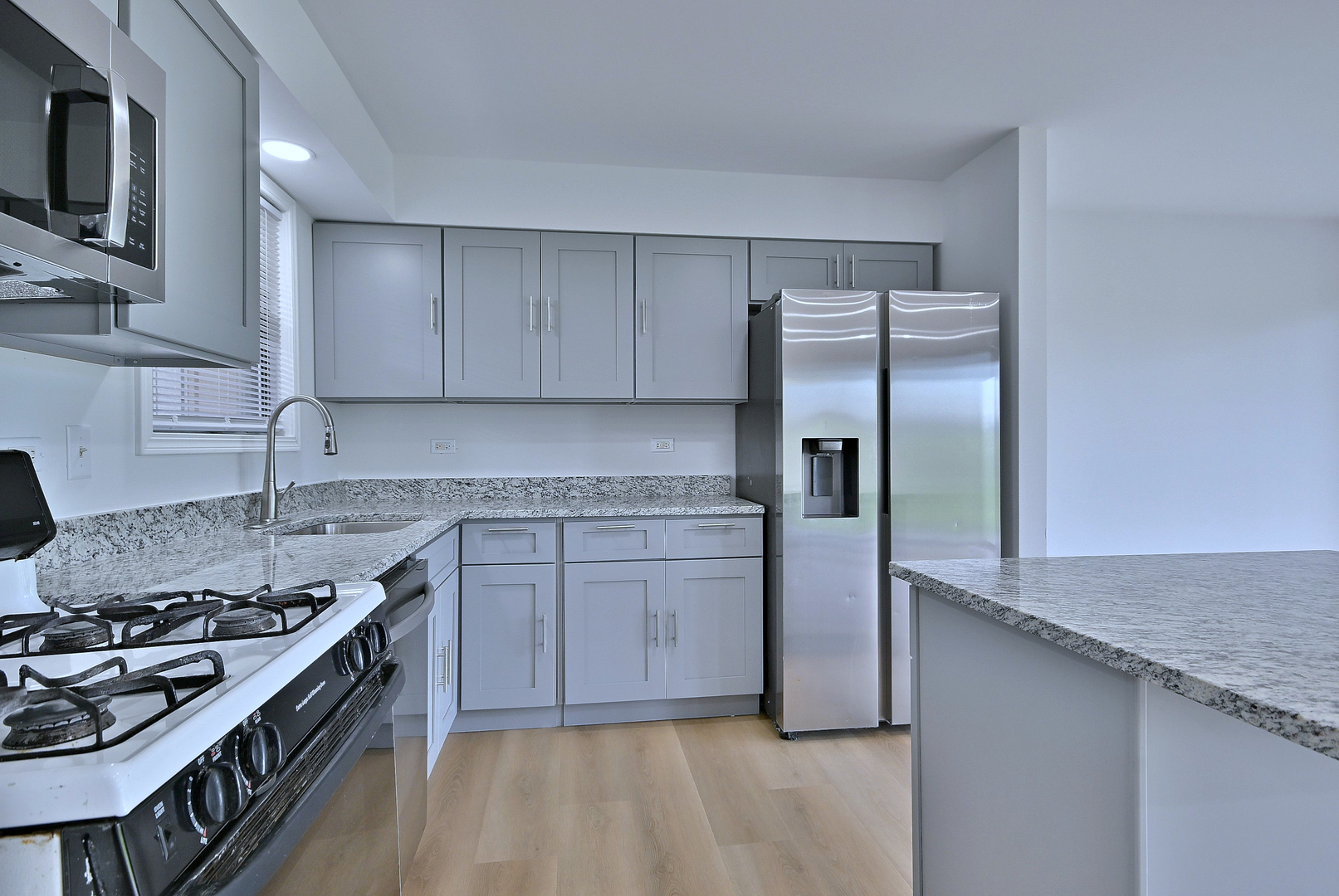 1395 Alpine Court, Unit C Hanover Park, IL 60133 - Photo 5 of 31 a kitchen with stainless steel appliances granite countertop a stove a refrigerator and a sink
