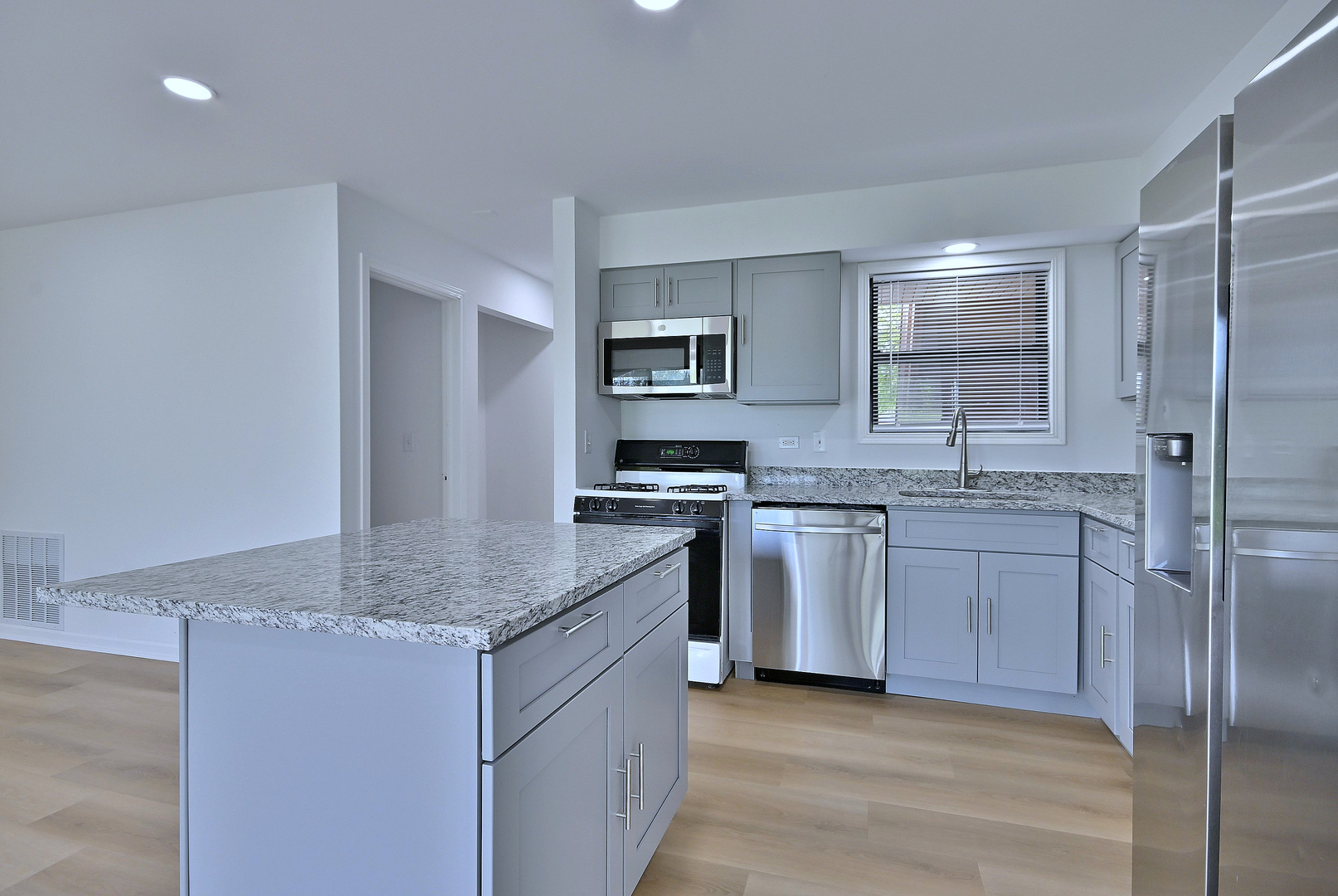 1395 Alpine Court, Unit C Hanover Park, IL 60133 - Photo 7 of 31 a kitchen with stainless steel appliances granite countertop a sink stove and refrigerator