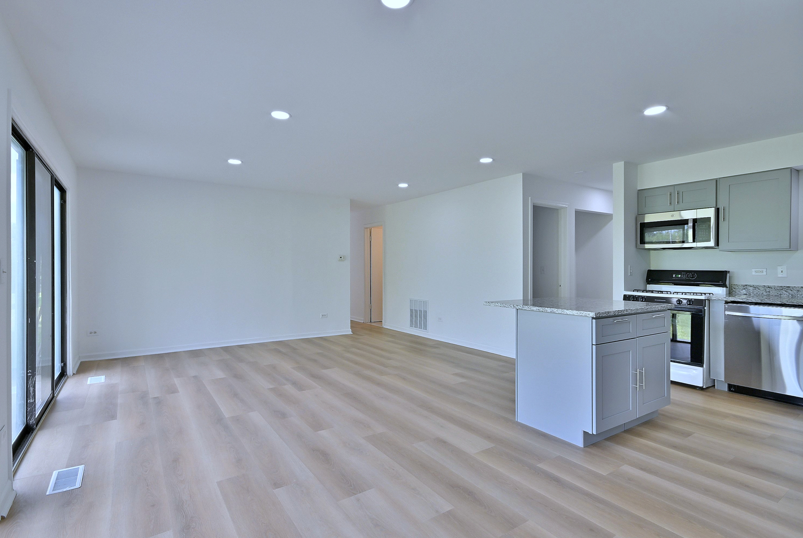 1395 Alpine Court, Unit C Hanover Park, IL 60133 - Photo 9 of 31 a view of kitchen with stainless steel appliances wooden floor and large window