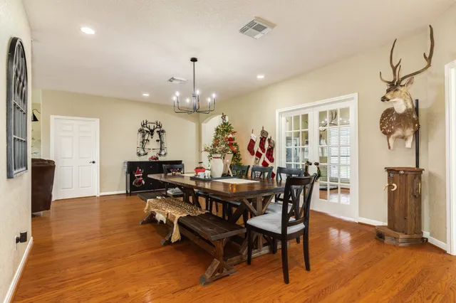 a view of a dining room with furniture and wooden floor
