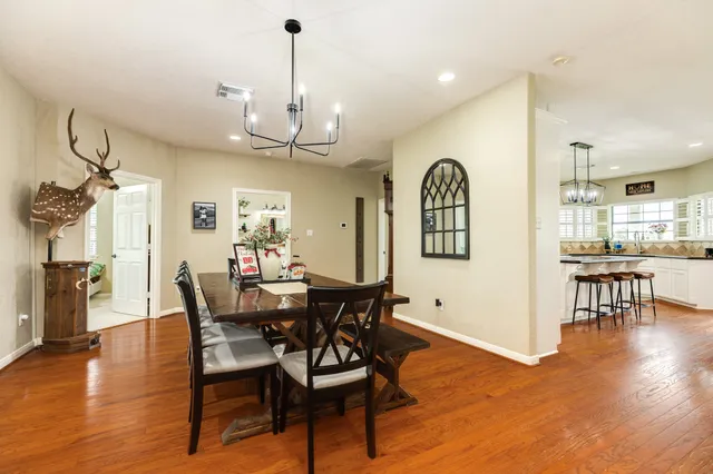 a view of a dining room with furniture and wooden floor