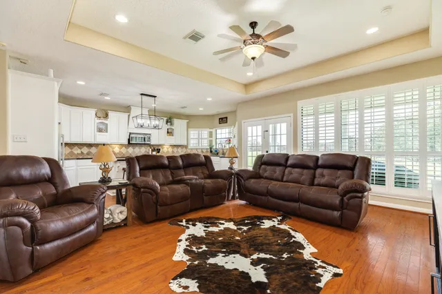 a living room with furniture and wooden floor