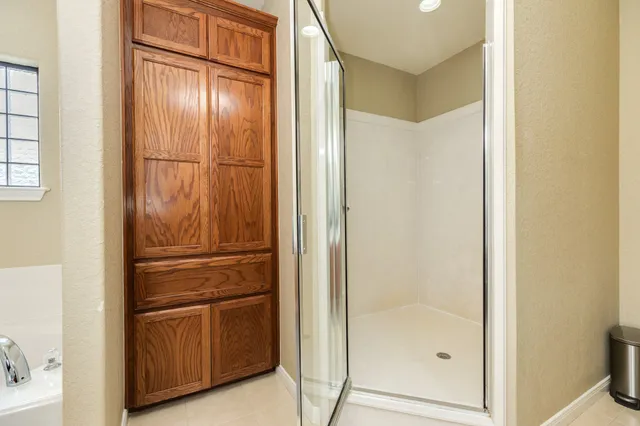 a bathroom with a glass shower door
