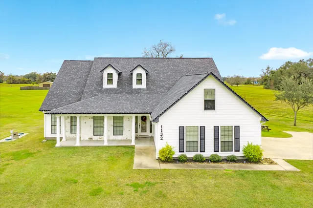 a front view of house with outdoor space and swimming pool